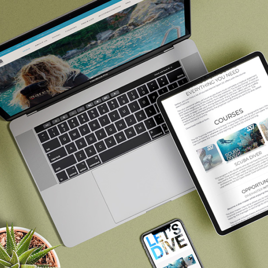 Photograph of a hand holding a smartphone displaying a purple IELTS learning app interface