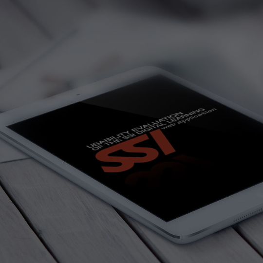 Photograph of a hand holding a smartphone displaying a purple IELTS learning app interface